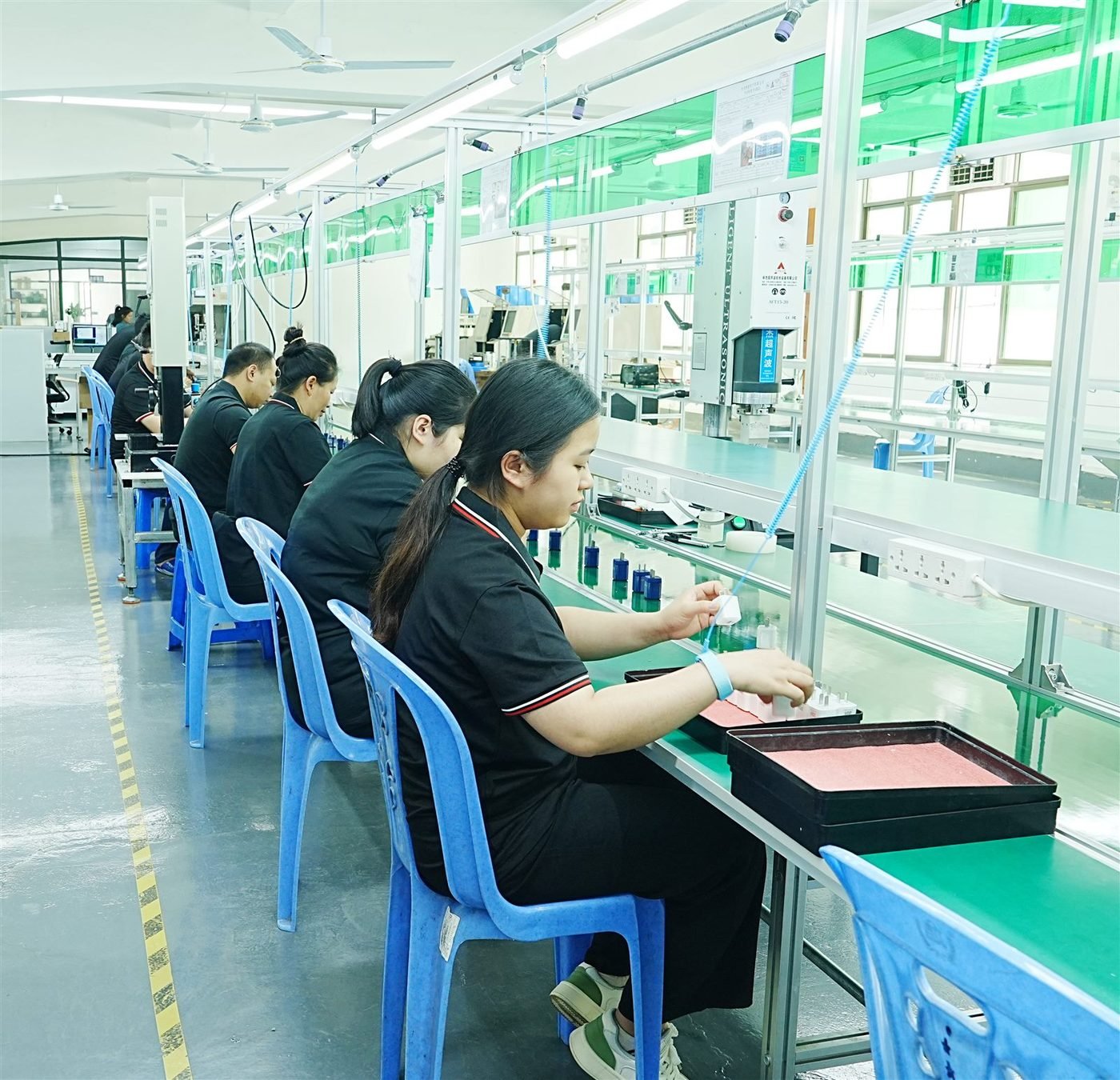 Assembly and packaging workshop with workers on the production line