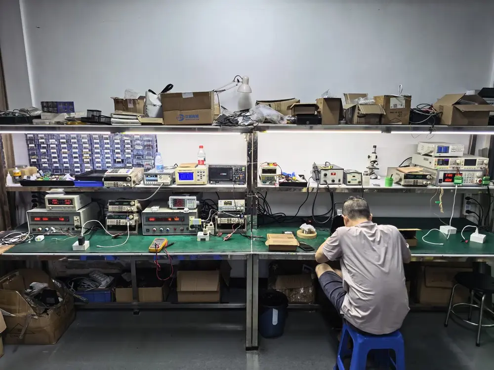 Engineering test bench with AC power sources, electronic loads, power meters and an oscilloscope for GaN charger development