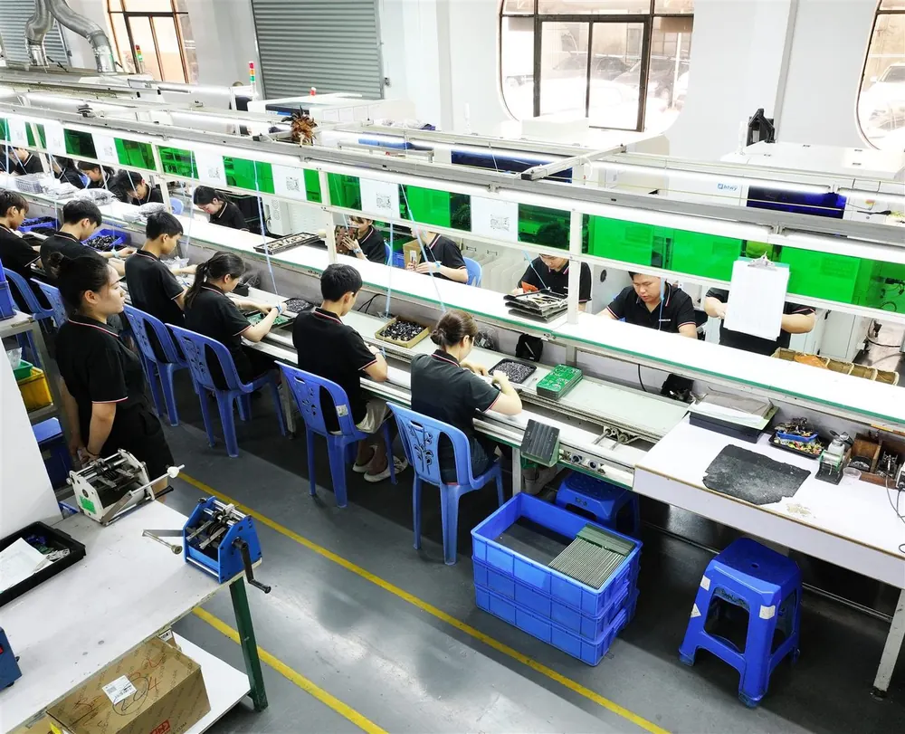 Workers assembling OEM GaN chargers on the Rongjun production line